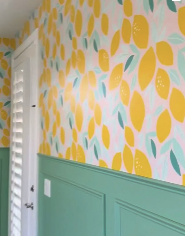 Lemon-print wallcovering above green wainscoting