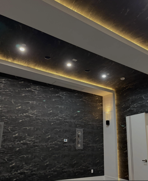 Black marble wallcovering with backlit cove ceiling