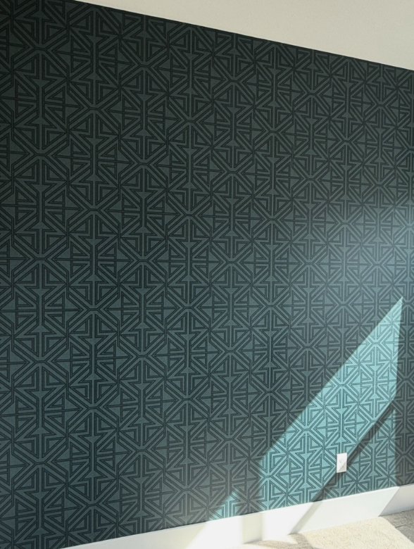 Teal geometric wallcovering in a sunlit room