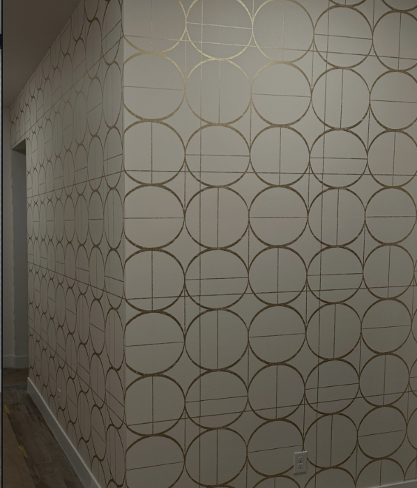 Gold geometric wallcovering in a hallway