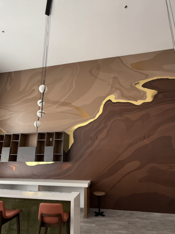 Sculpted brown and gold mural wall in a lounge