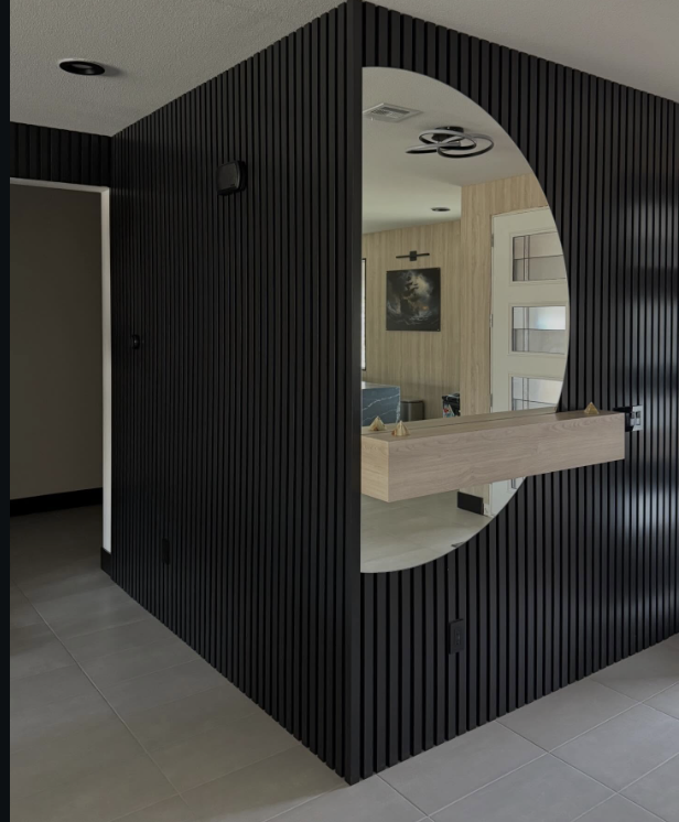 Black fluted feature wall with arched mirror cutout