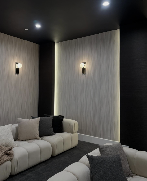 Home cinema with textured wallcovering and backlit niches